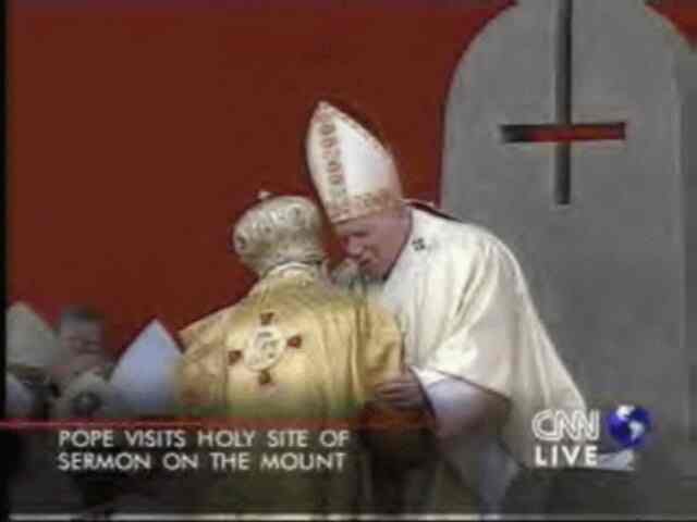 Pope with inverted cross on chair